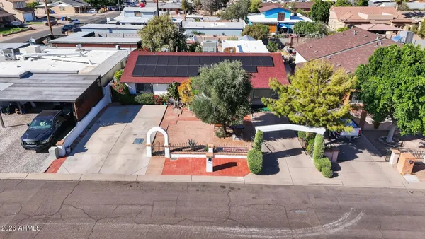 an aerial view of residential houses with yard