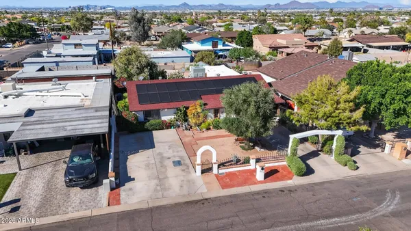 an aerial view of a house with yard swimming pool and ocean view