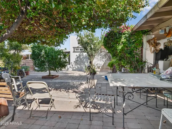 a view of a patio with table and chairs and potted plants