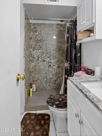 a bathroom with a granite countertop sink and a white stove