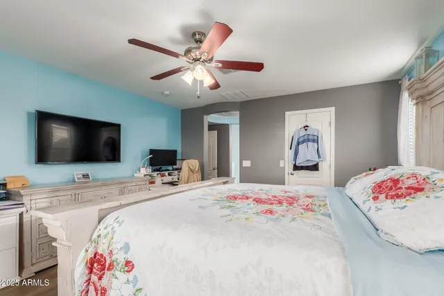 a bedroom with a bed and a flat screen tv