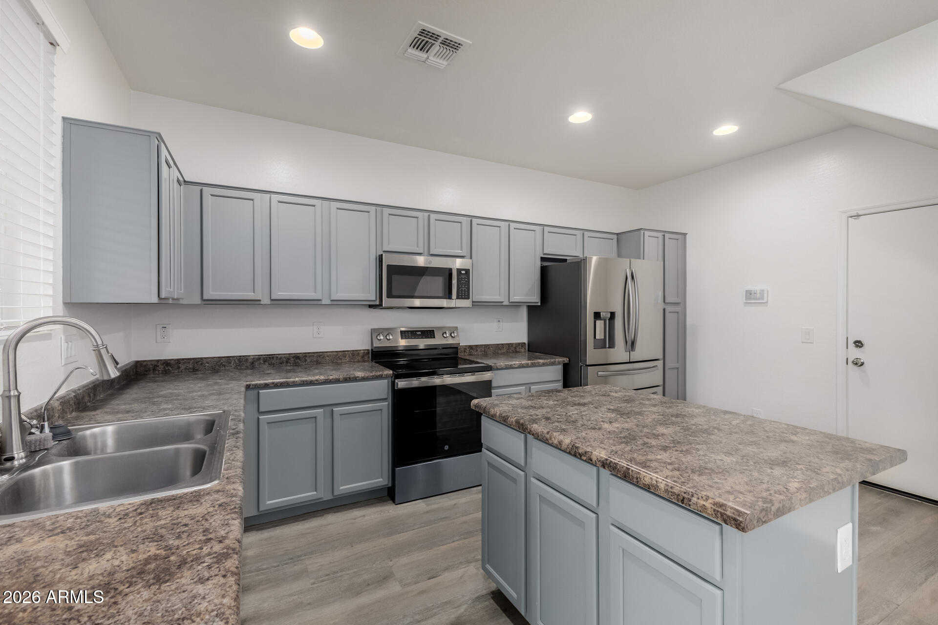 836 Constance Way Phoenix, AZ 85042 - Photo 12 of 51 a kitchen with stainless steel appliances granite countertop a sink stove and refrigerator