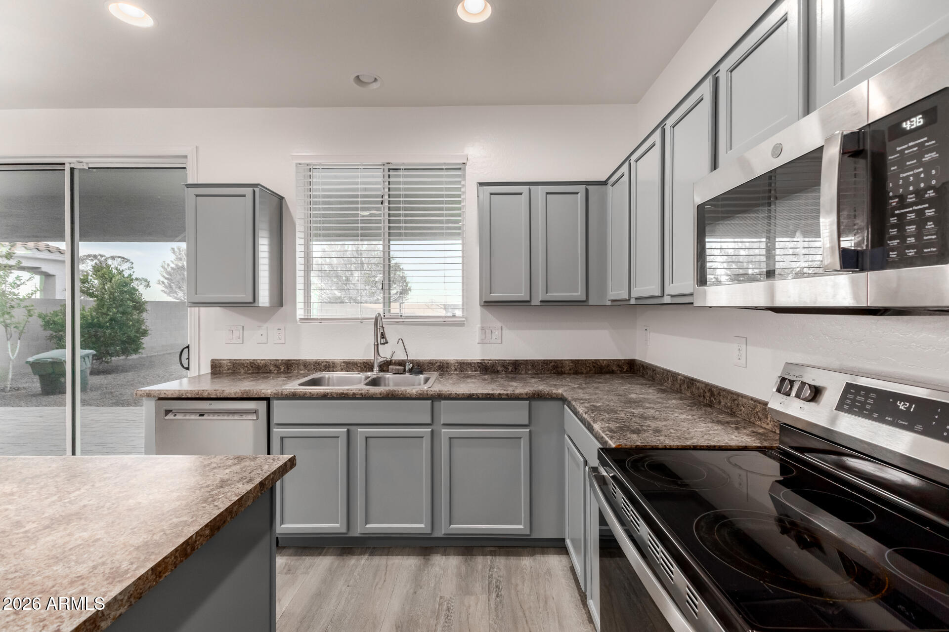 836 Constance Way Phoenix, AZ 85042 - Photo 14 of 51 a kitchen with stainless steel appliances granite countertop a sink stove and cabinets