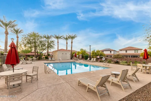 a swimming pool with trees in the background