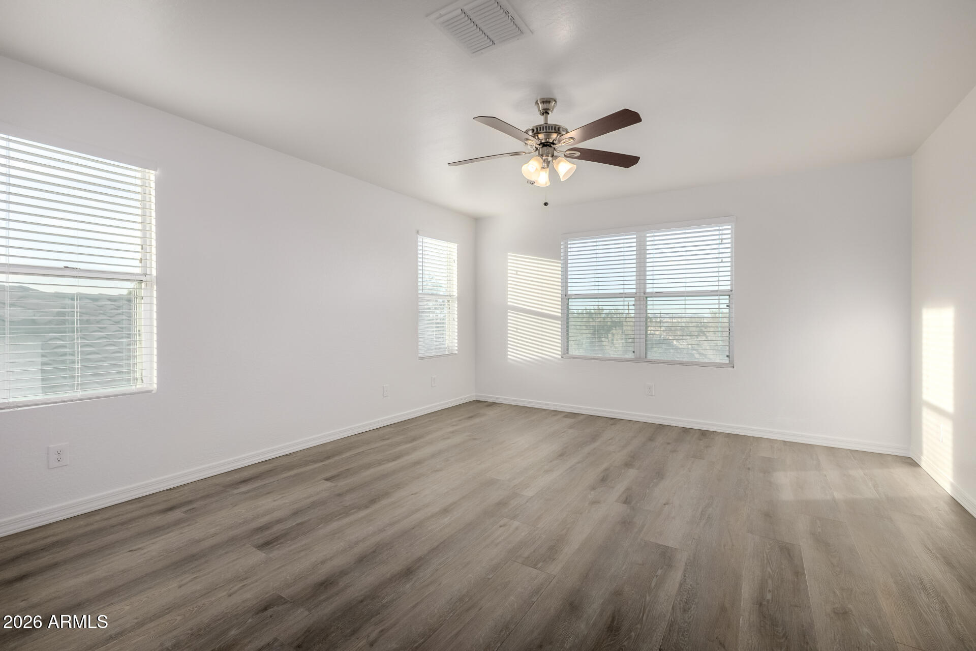 836 Constance Way Phoenix, AZ 85042 - Photo 16 of 51 a view of an empty room with a window and wooden floor