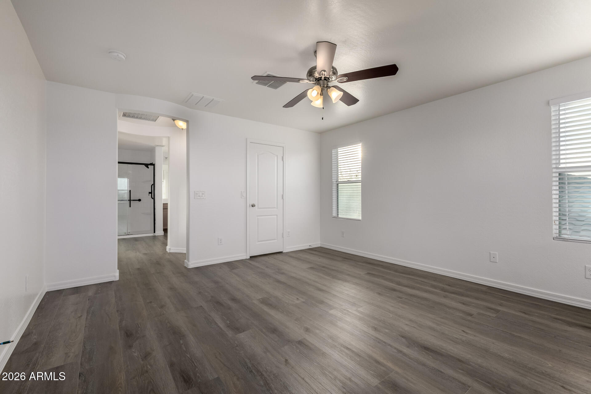 836 Constance Way Phoenix, AZ 85042 - Photo 18 of 51 a view of an empty room with wooden floor and a window