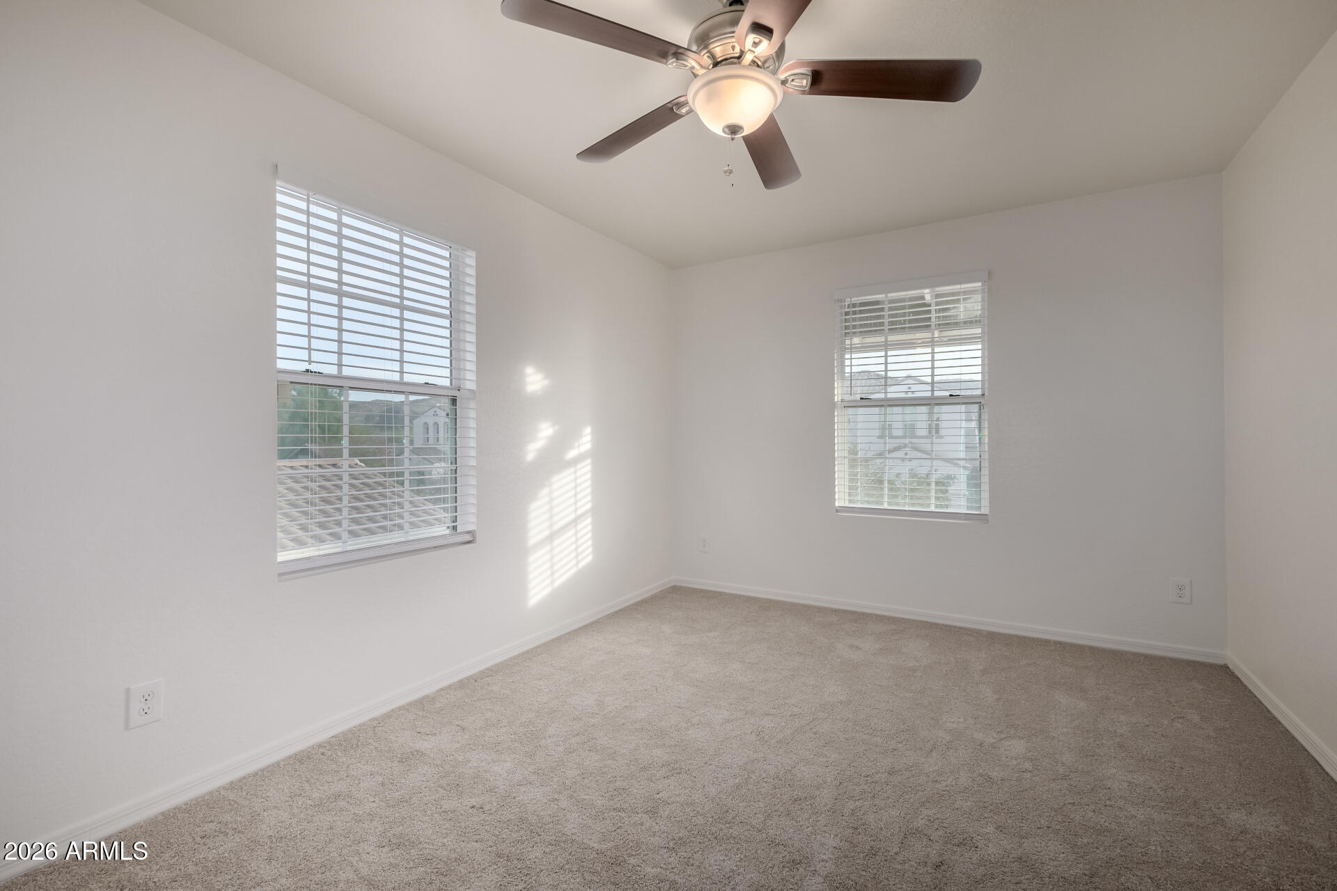 836 Constance Way Phoenix, AZ 85042 - Photo 23 of 51 an empty room with windows and fan