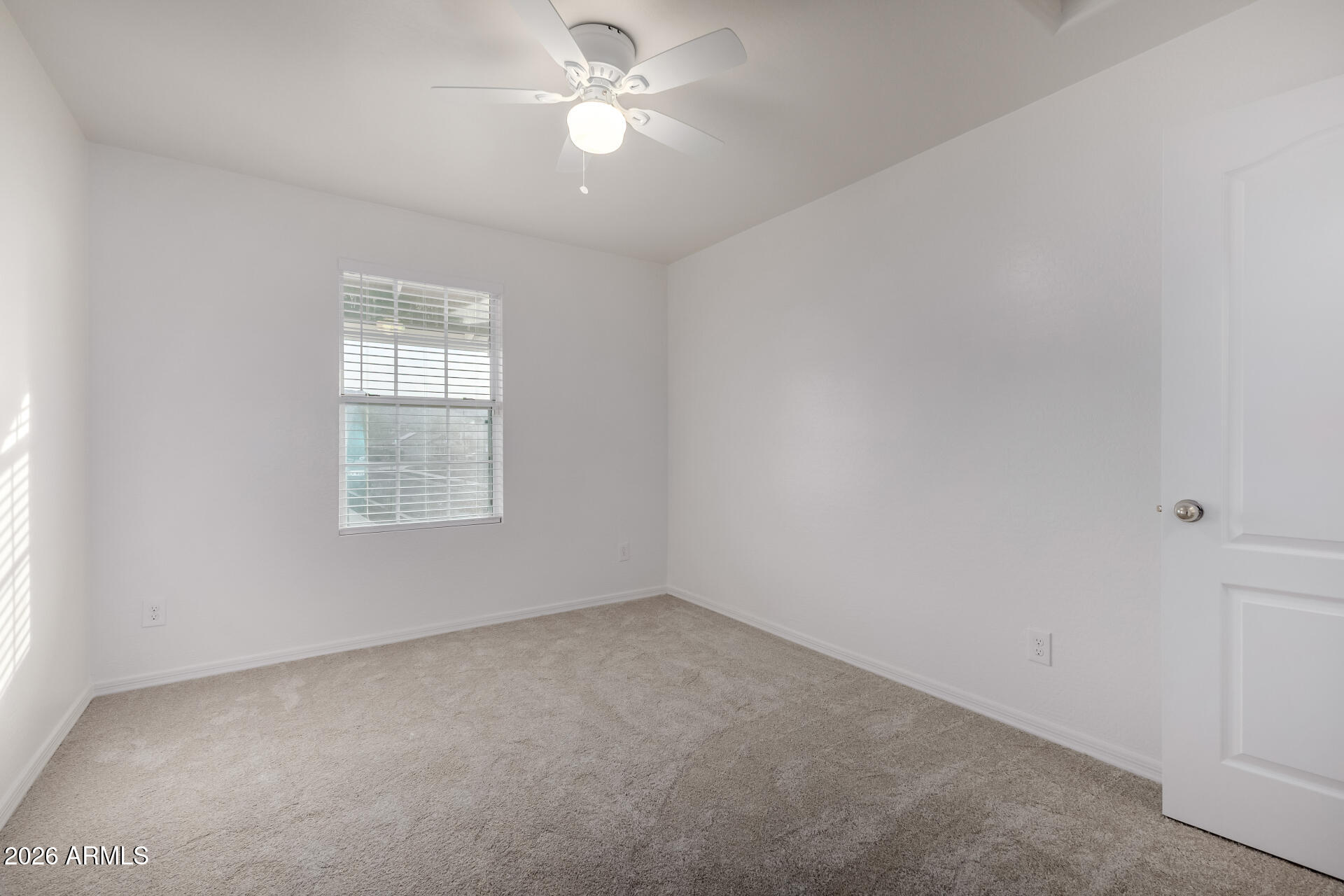 836 Constance Way Phoenix, AZ 85042 - Photo 25 of 51 an empty room with a window and a fan