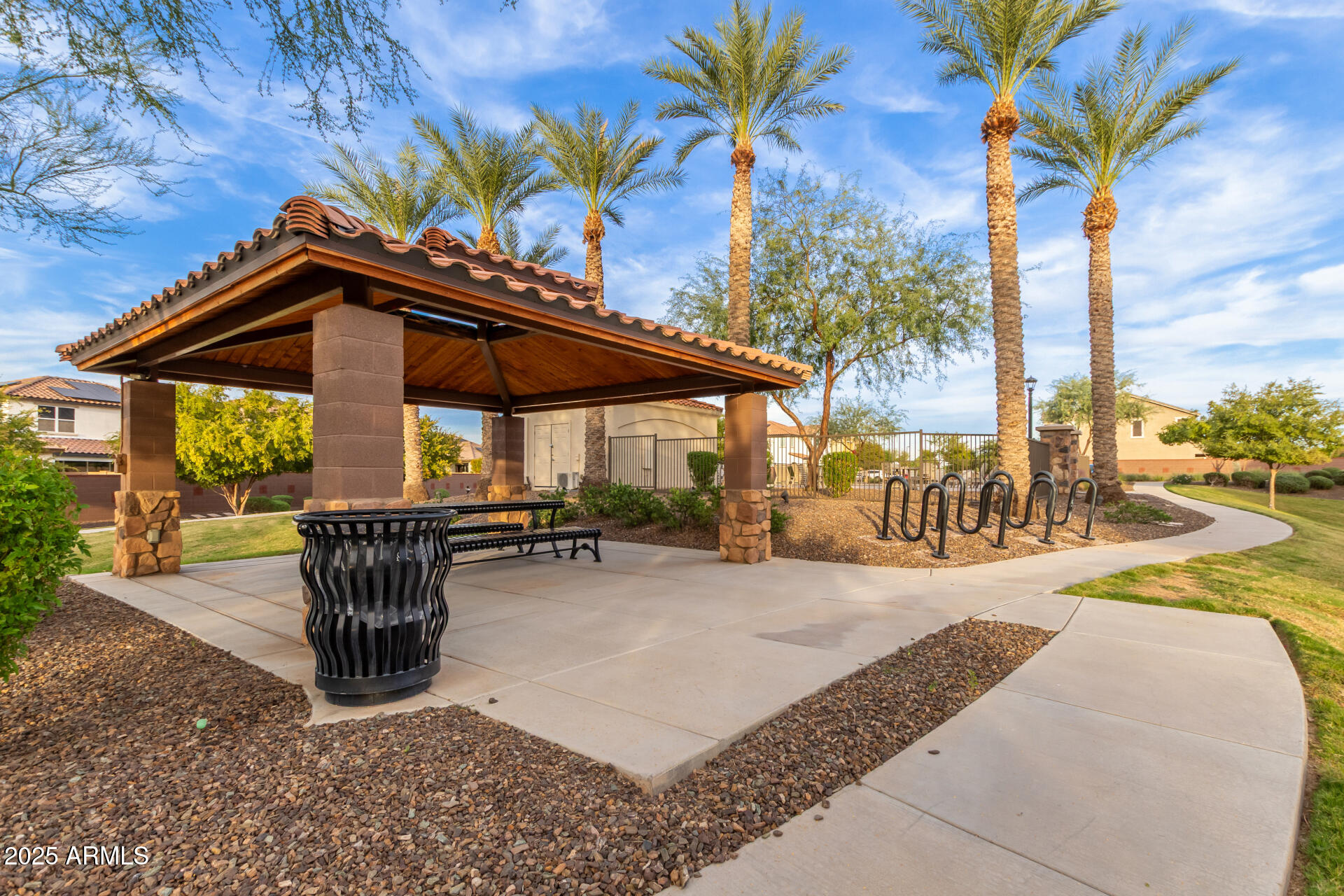 836 Constance Way Phoenix, AZ 85042 - Photo 37 of 51 a patio with a table and chairs under an umbrella