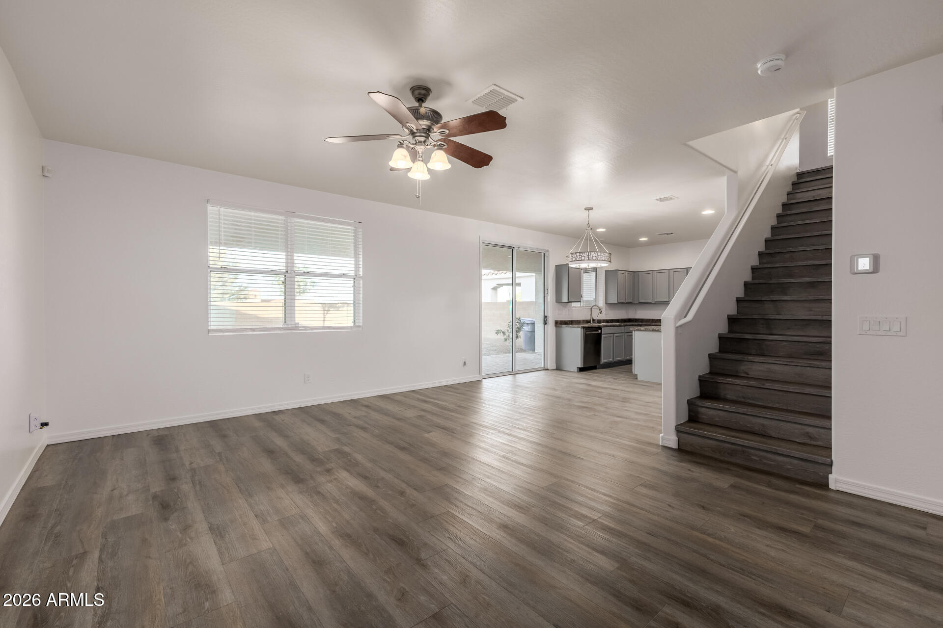 836 Constance Way Phoenix, AZ 85042 - Photo 6 of 51 a view of an empty room with wooden floor and a window