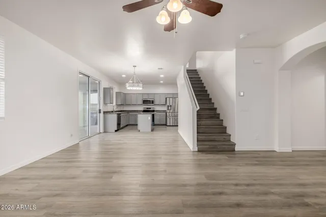 a kitchen with stainless steel appliances granite countertop a sink stove and cabinets