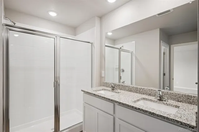 a bathroom with a granite countertop sink mirror and double