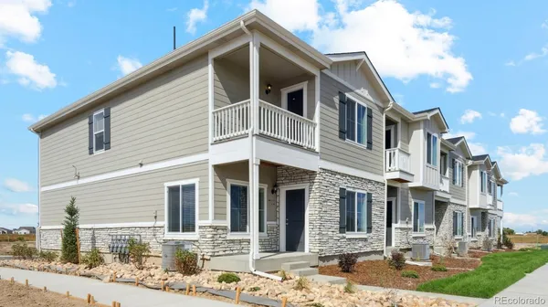 a front view of a house with yard and seating space