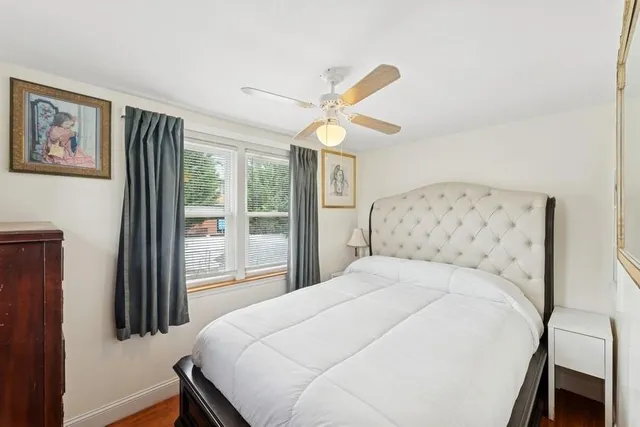 a bedroom with a large bed and a window