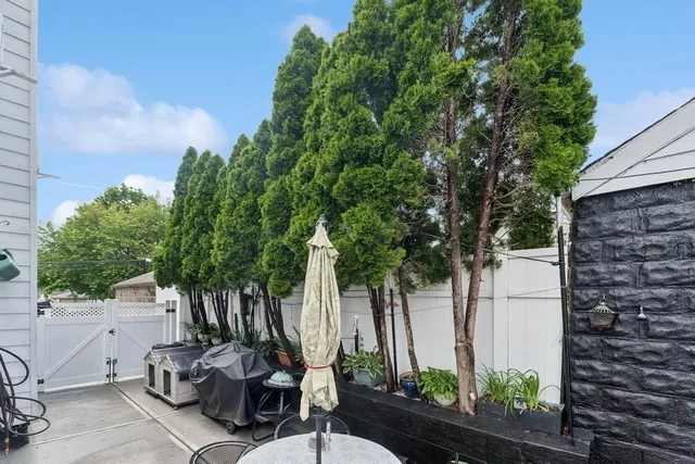 a view of a patio with table and chairs and potted plants
