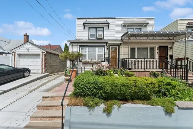 a front view of a house with garden