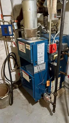 a living room with furniture and a air conditioner vent