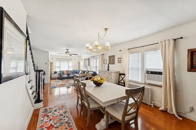 a view of a a dining room with furniture window and wooden floor