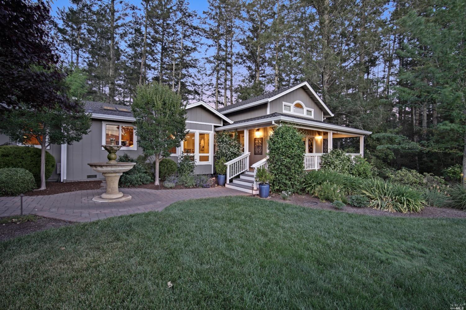 a front view of a house with a garden and yard