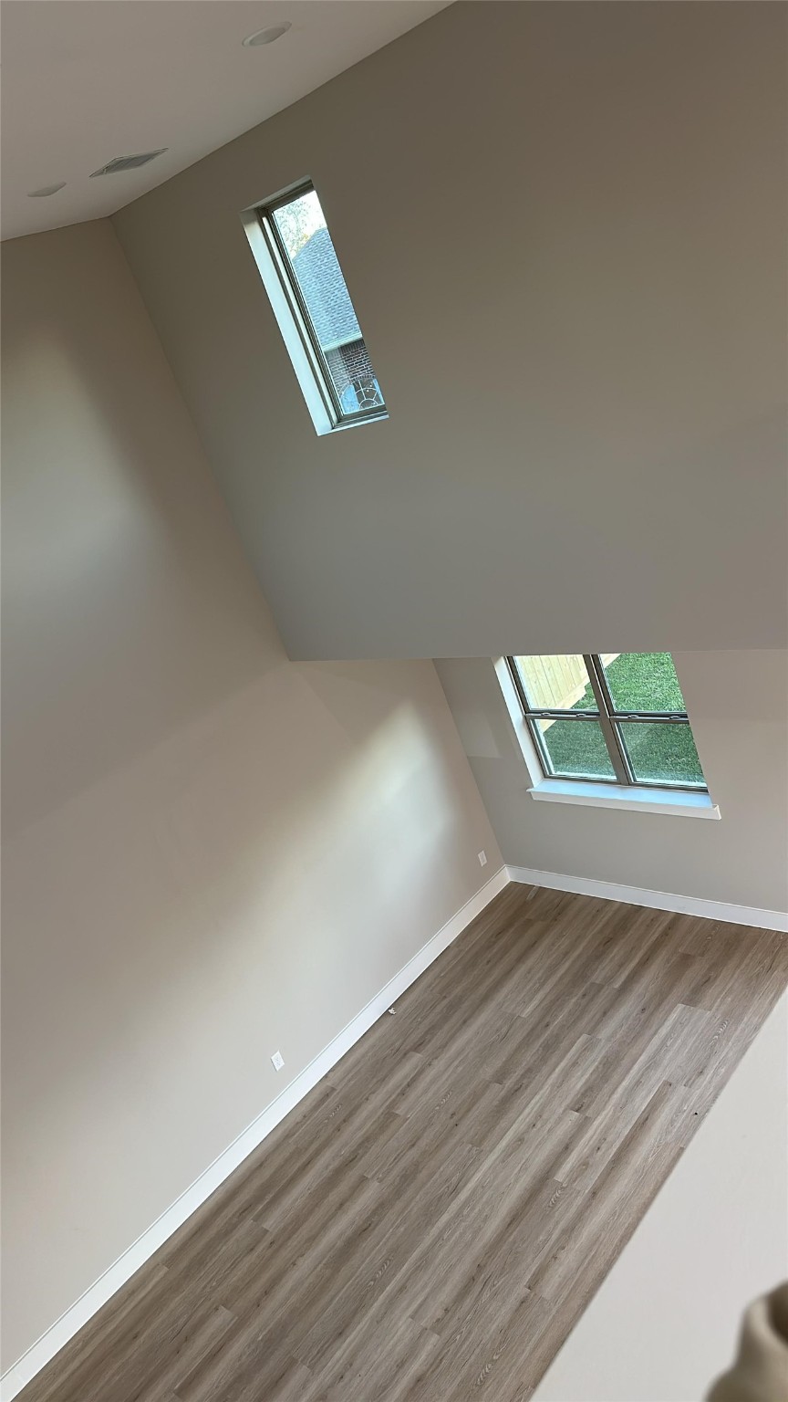 20003 Venetto St Spring Spring, TX 77388 - Photo 3 of 8 an empty room with wooden floor and windows