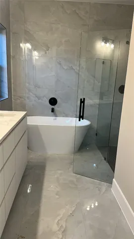 a bathroom with a bathtub and sink