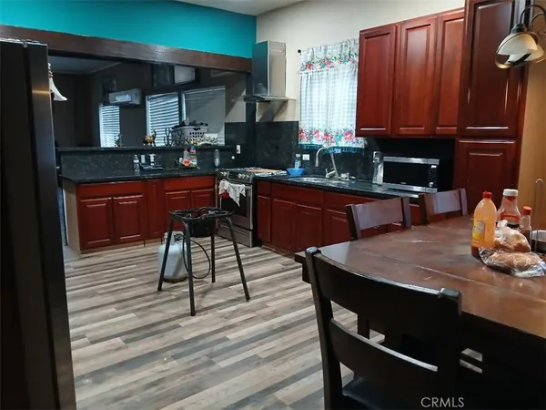 a kitchen with a wooden table chairs and cabinets