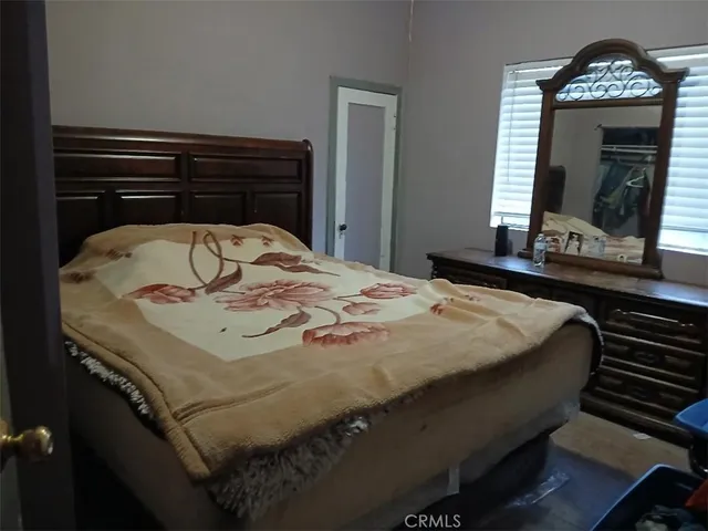 a bed sitting in a bedroom and dresser