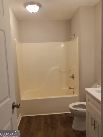 a bathroom with a toilet a sink and shower
