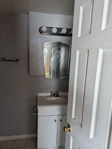 a bathroom with a sink toilet and mirror