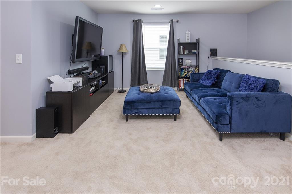 4615 David Cox Road Charlotte, NC 28269 - Photo 12 of 20 a living room with furniture and a flat screen tv