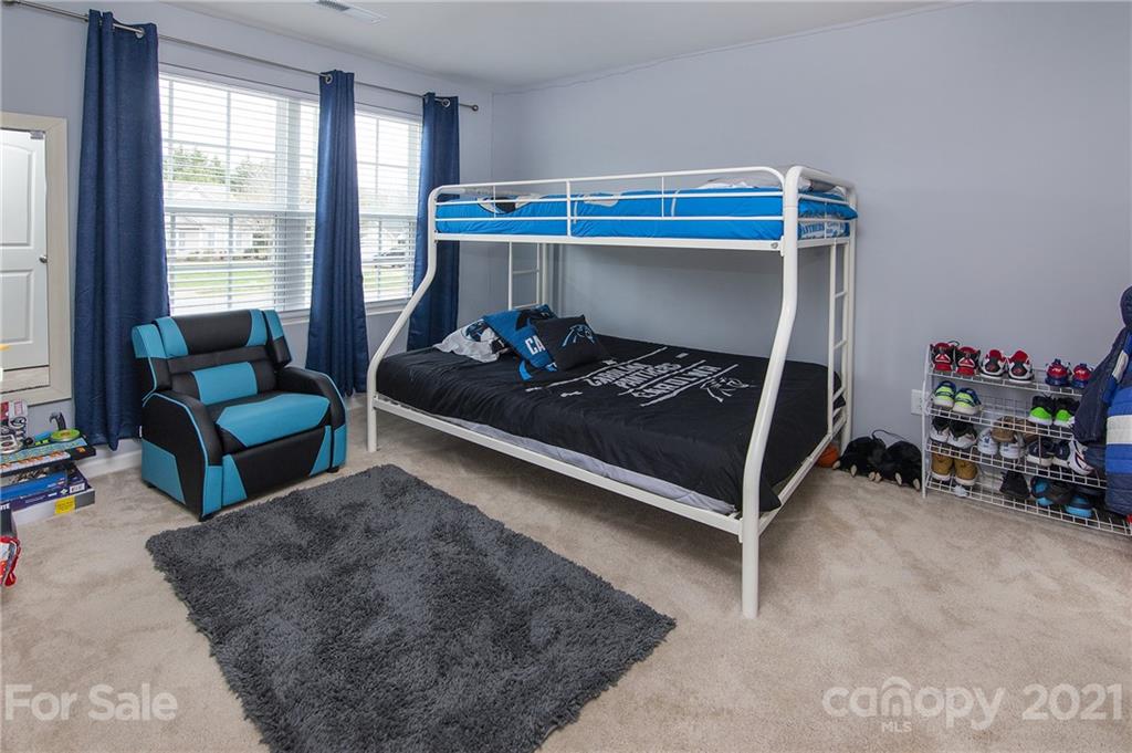 4615 David Cox Road Charlotte, NC 28269 - Photo 16 of 20 a bedroom with furniture and a window