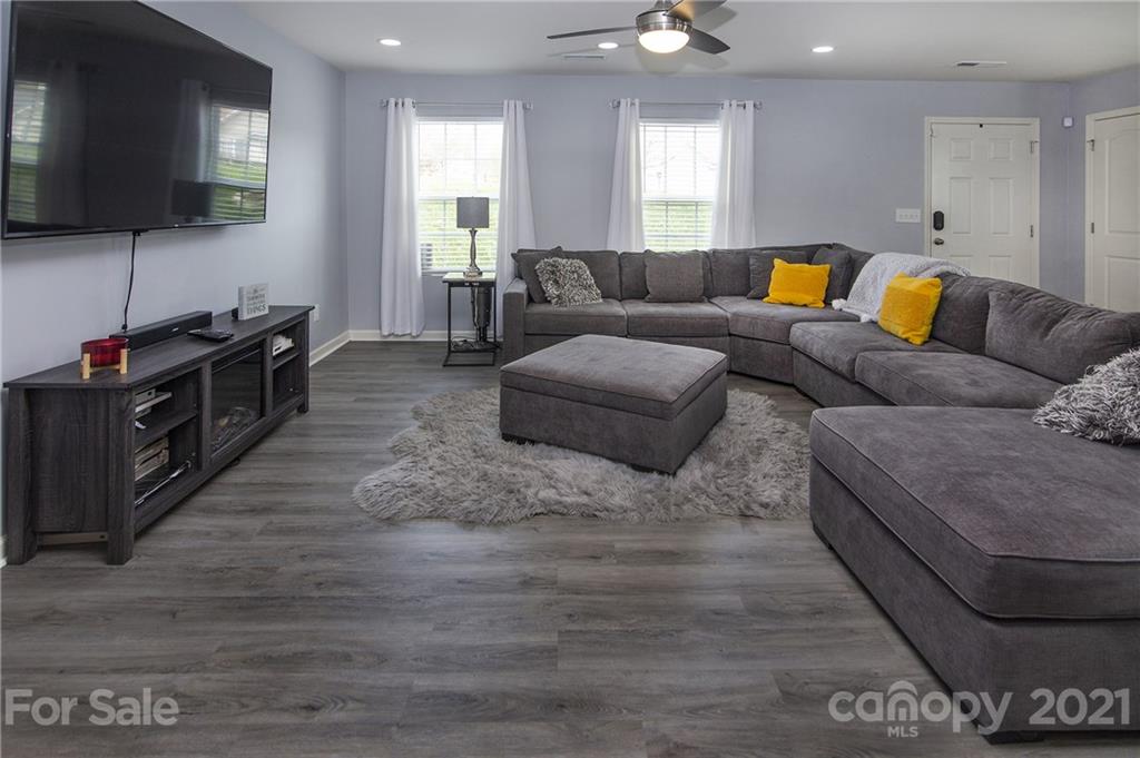 4615 David Cox Road Charlotte, NC 28269 - Photo 3 of 20 a living room with furniture and a flat screen tv