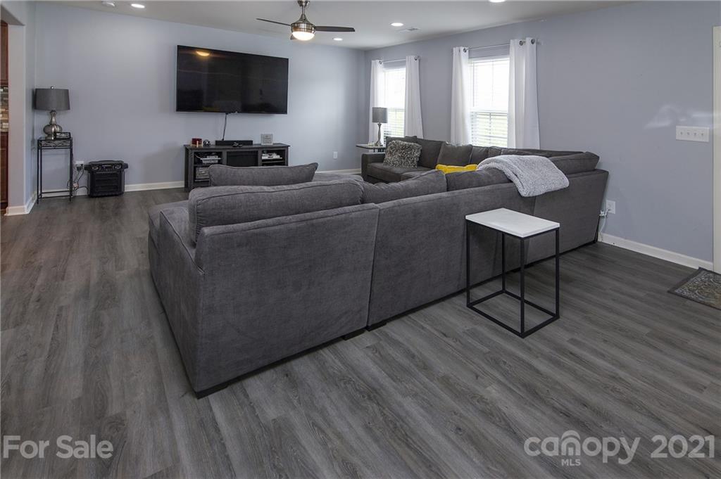 4615 David Cox Road Charlotte, NC 28269 - Photo 4 of 20 a living room with furniture and a flat screen tv