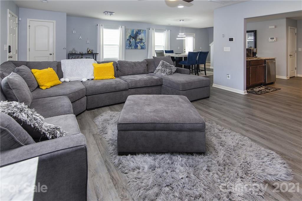 4615 David Cox Road Charlotte, NC 28269 - Photo 5 of 20 a living room with furniture and a wooden floor