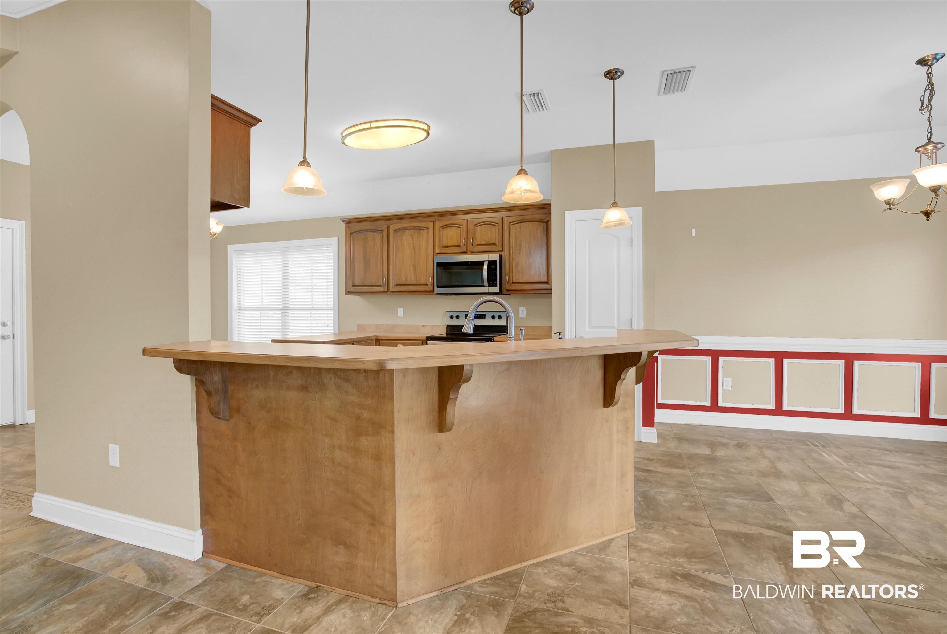 9532 Collier Loop Daphne, AL 36526 - Photo 18 of 45 Kitchen featuring stainless steel appliances, hanging light fixtures, and a kitchen breakfast bar