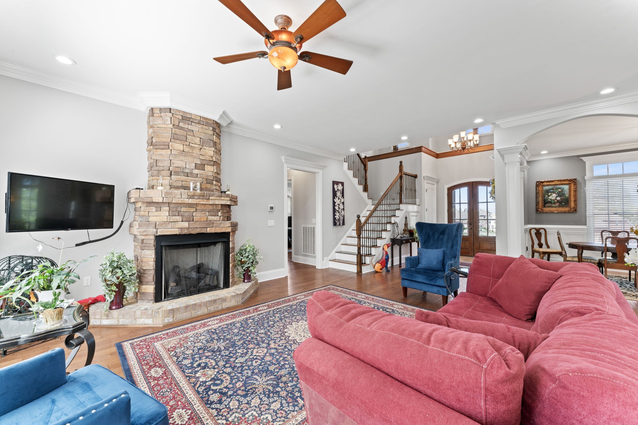 7402 Cold Harbor Court Fairview, TN 37062 - Photo 5 of 48 a living room with furniture a flat screen tv and a fireplace