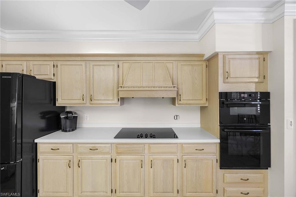 828 Hideaway Circle East, Unit 4434 Marco Island, FL 34145 - Photo 16 of 50 a kitchen with a refrigerator a stove a sink and cabinets