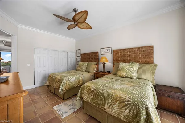 a bedroom with two beds and a chandelier