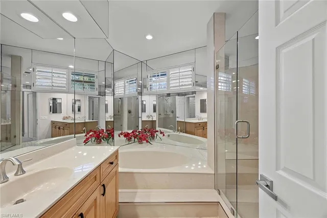 a spacious bathroom with a shower sink and mirror