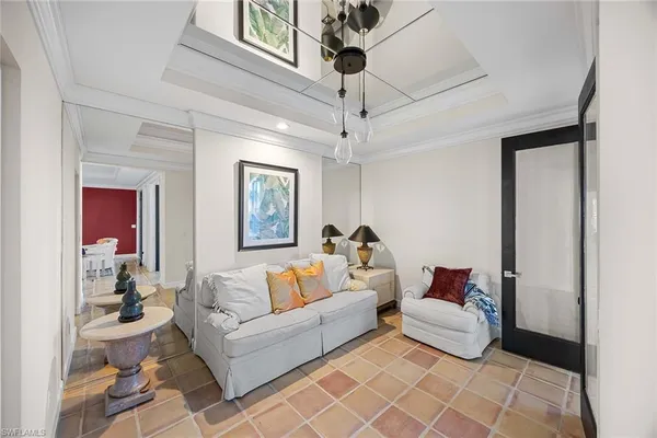 a living room with furniture and a chandelier