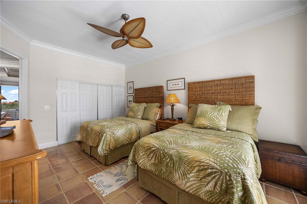 828 Hideaway Circle East, Unit 4434 Marco Island, FL 34145 - Photo 30 of 50 a bedroom with two beds and a chandelier
