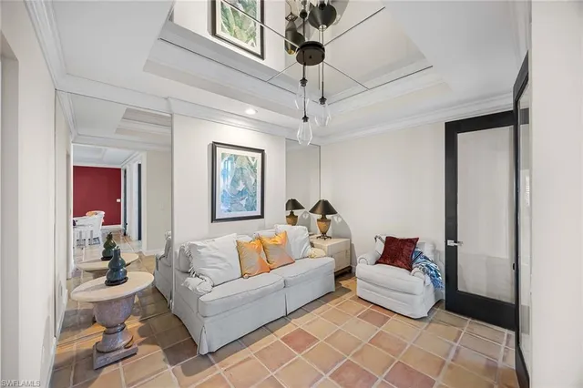 a living room with furniture and a chandelier