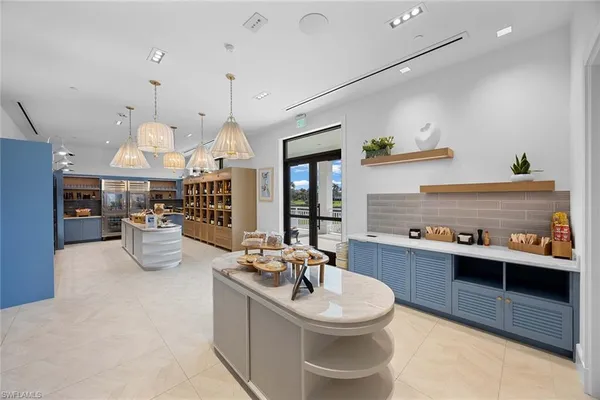 a kitchen with stainless steel appliances granite countertop a sink and a refrigerator