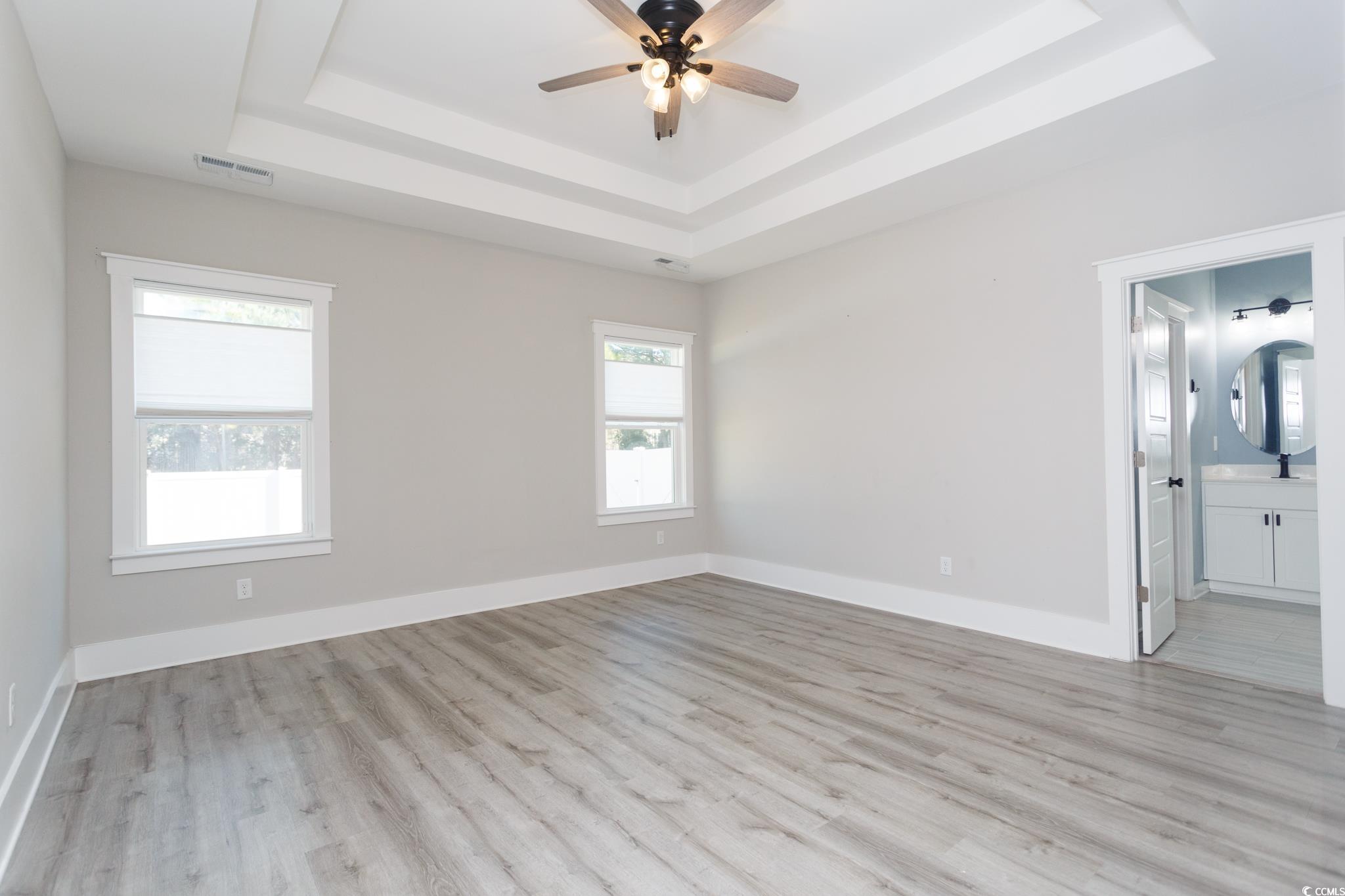 261 Marsh Tacky Loop Myrtle Beach, SC 29588 - Photo 18 of 40 Spare room with light hardwood / wood-style floors, a raised ceiling, and ceiling fan