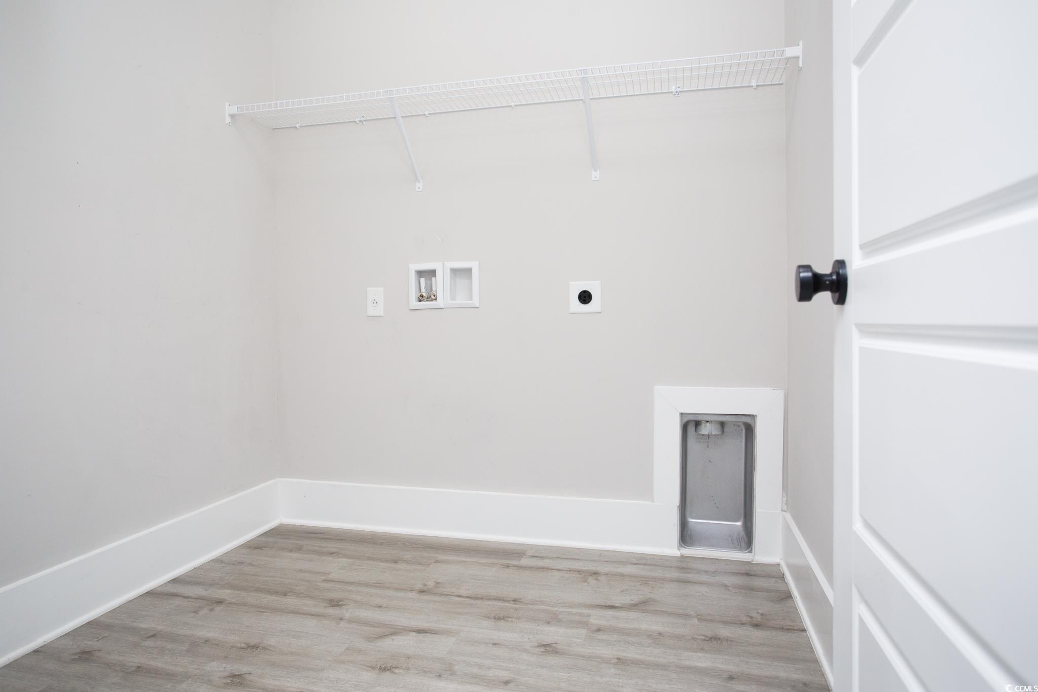 261 Marsh Tacky Loop Myrtle Beach, SC 29588 - Photo 21 of 40 Laundry room with hookup for an electric dryer, hookup for a washing machine, and light hardwood / wood-style flooring