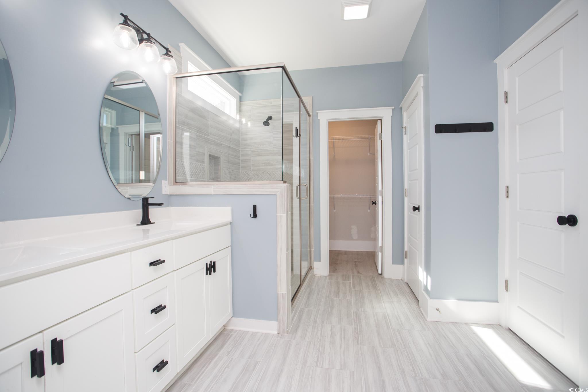 261 Marsh Tacky Loop Myrtle Beach, SC 29588 - Photo 24 of 40 Bathroom with vanity and an enclosed shower
