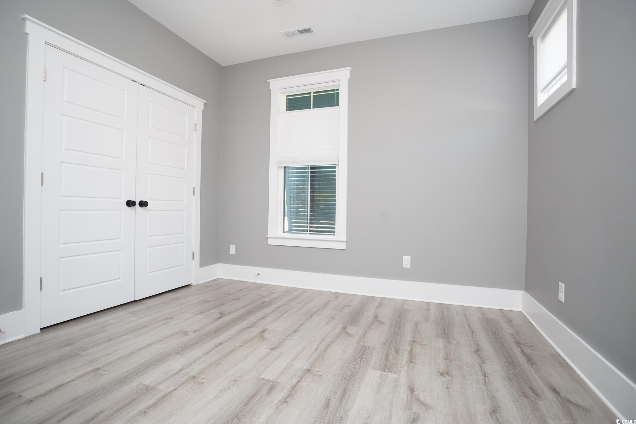 261 Marsh Tacky Loop Myrtle Beach, SC 29588 - Photo 35 of 40 Unfurnished bedroom featuring light hardwood / wood-style floors and a closet