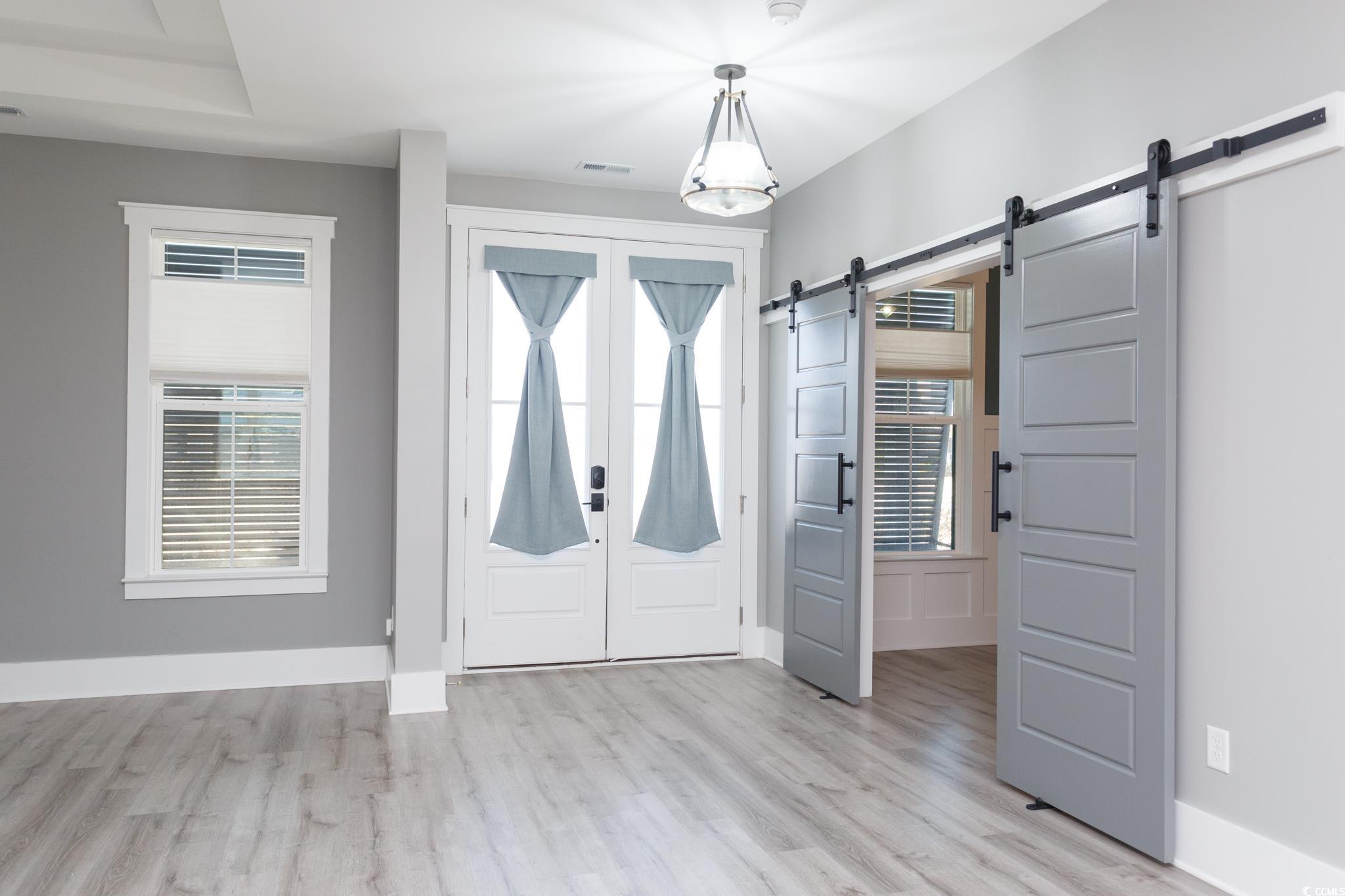 261 Marsh Tacky Loop Myrtle Beach, SC 29588 - Photo 5 of 40 Entryway with light hardwood / wood-style floors and a barn door