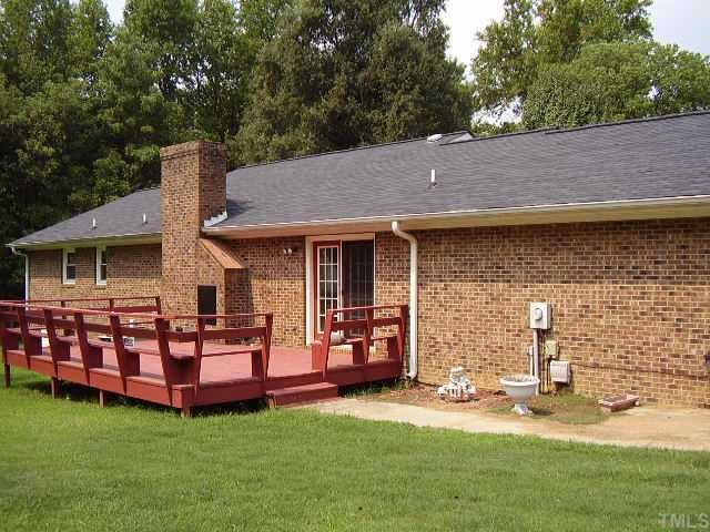2777 Burlington Road Roxboro, NC 27574 - Photo 6 of 11 a front view of a house with patio and garden
