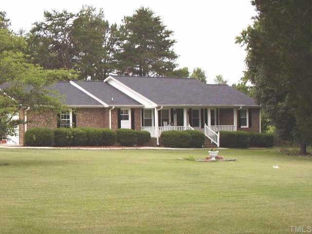 2777 Burlington Road Roxboro, NC 27574 - Photo 7 of 11 a front view of a house with a yard and trees